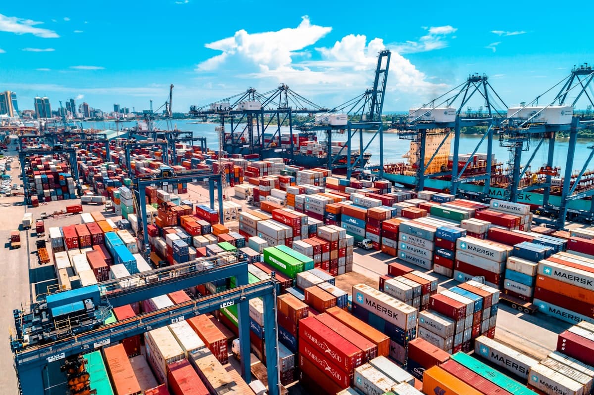 Aerial view of a container port stacked with freight and gantry cranes
