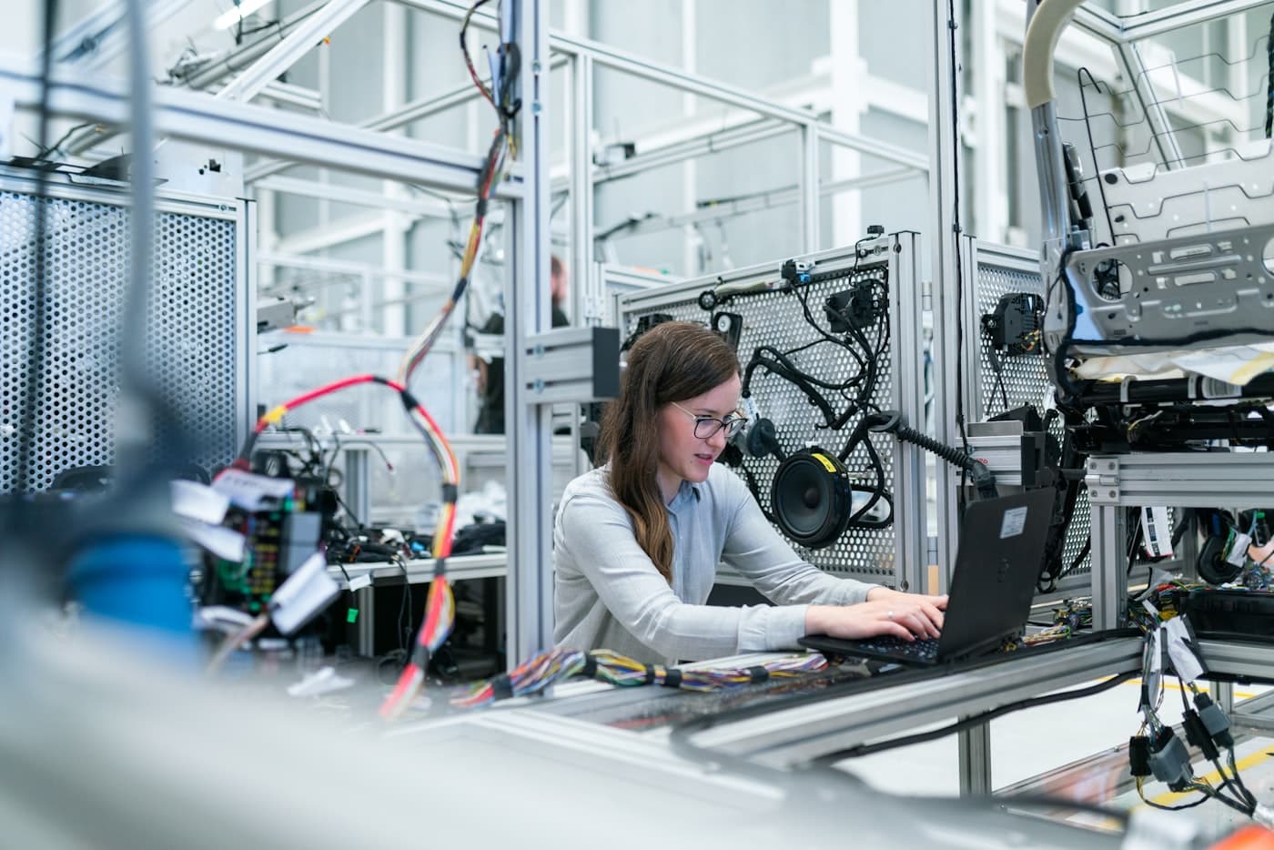 Engineer working on a laptop beside test infrastructure